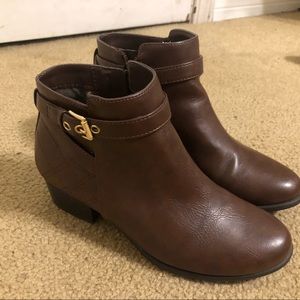 Brown boots with golden buckle and they are heeled